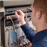 Technician Cleaning Ports with Fiber Optic Cleaning Swabs
